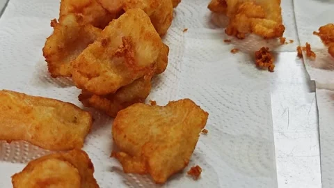 Crispy fried fish pieces draining on paper towels. Stock Footage 342737413