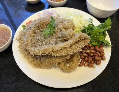 Crispy Fried Fish Skin Served with Green Mango Salad and Peanuts  Stock Photos