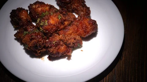 Crispy fried nuggets on a plate spin on the table Stock Footage 122849409