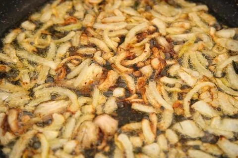 Crispy Fried Onion Bits with oil in the pan. Deep fried onion. Homemade fryin Stock Photos