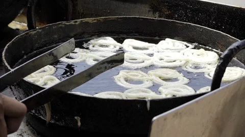 Crispy Fried Onion Rings in a Batch Stock Footage 316272951