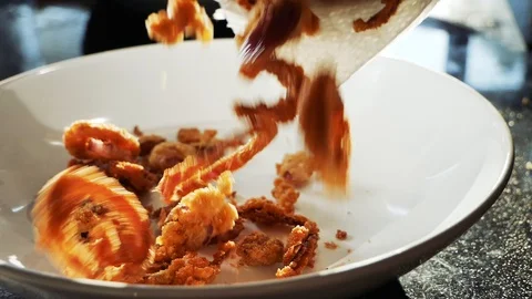 Crispy fried onion rings falling into bowl Stock Footage 105102578