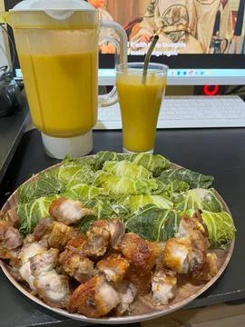 Crispy fried pork, cabbage, and smoothie Stock Photos
