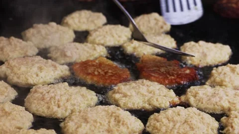Crispy fried potato pancakes on large griddle, rustic delicious street food Stock Footage 315093621