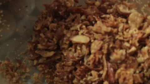 Crispy fried shallots inside glass jar close up food garnish Stock Footage 326440467