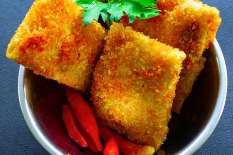 Crispy fried spring rolls with chili and cilantro garnish Stock Photos