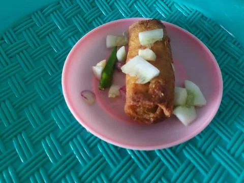 Crispy fried spring rolls topped with pickles and chili Stock Photos