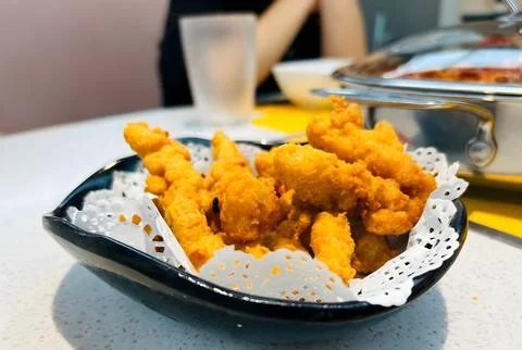 Crispy fried squid rings in a decorative bowl. Stock Photos