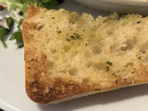 Crispy Garlic Bread Slice With Herbs On White Plate Stock Photos