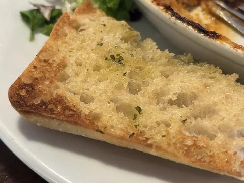 Crispy Garlic Bread Slice With Herbs On White Plate Stock Photos