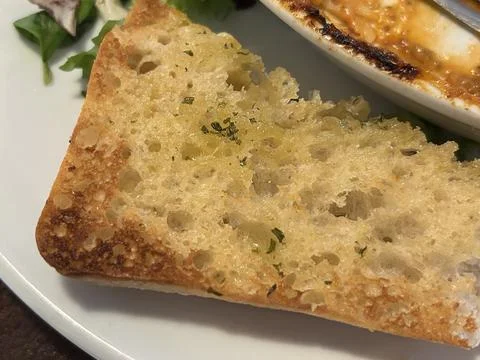 Crispy Garlic Bread Slice With Herbs On White Plate Stock Photos