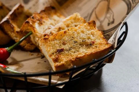 Crispy garlic bread slices in basket Stock Photos