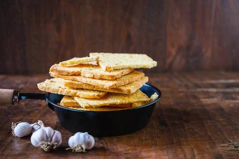 .Crispy garlic bread on a wooden table Stock Photos