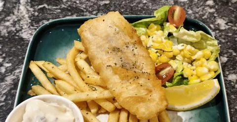 Crispy golden battered fried fish 스톡 사진