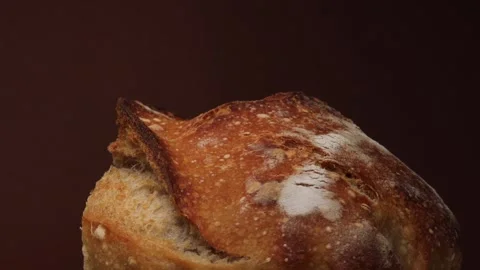 Crispy golden bread crust in closeup view rotating to show detailed bubbles and Stock Footage 311511623