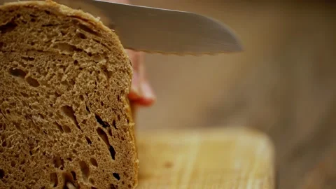 Crispy golden crust of warm bread. baker in a bakery. a man cuts pieces of bread Stock Footage 201265530