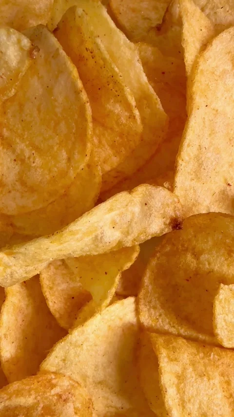 Crispy golden potato chips served in a white bowl Stock Footage 331976098