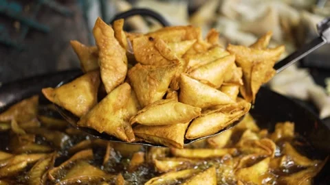Crispy Golden samosas being drained of oil Stock Footage 331341577