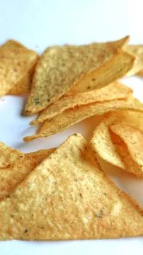 Crispy Golden Triangle Corn Chips Close Up Snack Texture Background Stock-Fotos