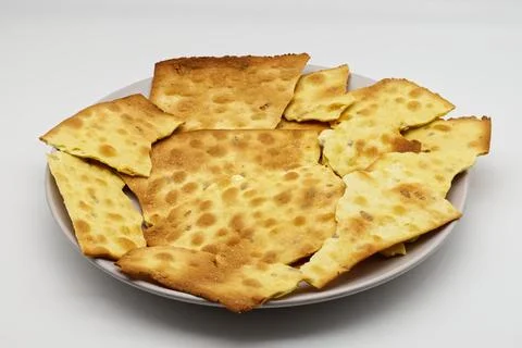 Crispy golden yellow flatbread crackers on a light plate Stock Photos