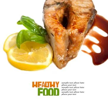 Crispy grilled salmon steak with lemon and basil Stock Photos