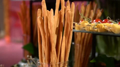 Crispy grissini and appetizers for guests on buffet table in hotel restaurant Stockbeeldmateriaal 131875264