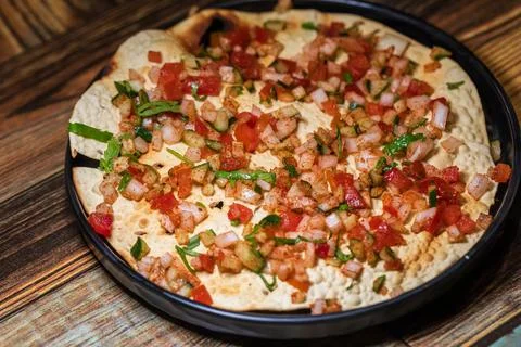 Crispy Indian flatbread with refreshing chopped vegetables Stock Photos
