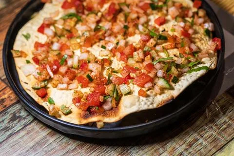 Crispy Indian flatbread with refreshing chopped vegetables Stock Photos