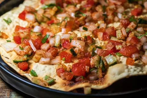 Crispy Indian flatbread with refreshing chopped vegetables Stock Photos