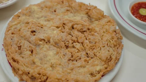 Crispy Indonesian Fried Omelette Served on a Plate Stock Footage 345044343