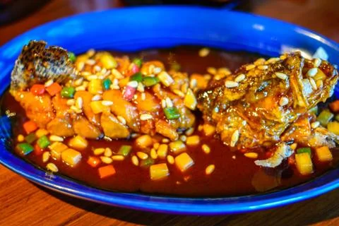 Crispy Mandarin Fish deep fried and the cooked in Sweet and Sour Sauce Stock Photos