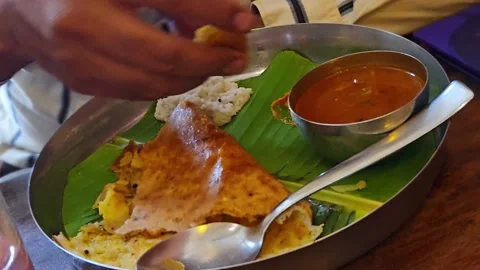 Crispy masala dosa filled with spiced potatoes served traditionally on a fresh g Video stock 342992715