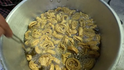 Crispy Moroccan calamari rings are deep-fried in bubbling oil and coated in Stock Footage 329162260