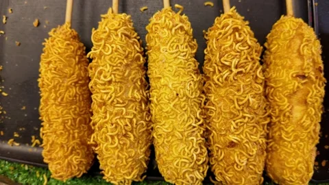 Crispy Noodle Coated Corn Dogs at Thai Street Food Market 4K Stock Footage 332636051