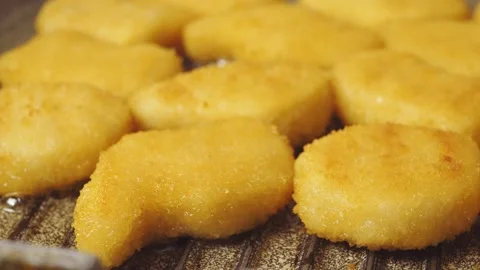 Crispy nuggets are fried in a pan in oil Stock Footage 169308967