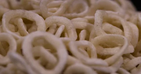 Crispy onion rings made from onion puree and flour fried in a large amount of Stock Footage 327828101