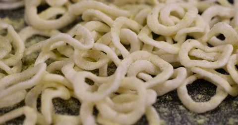 Crispy onion rings made from onion puree and flour fried in a large amount of Stock Footage 328096728