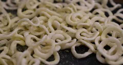 Crispy onion rings made from onion puree and flour fried in a large amount of Stock Footage 328226782