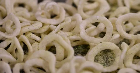 Crispy onion rings made from onion puree and flour fried in a large amount of Stock Footage 328446542