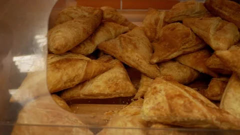 Crispy pastry close-up. Appetizing samosa. Bakery products on a store window Stock Footage 270897748