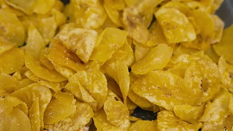 Crispy Peruvian chifles fried plantain chips in a bowl. Stock Footage 341440817