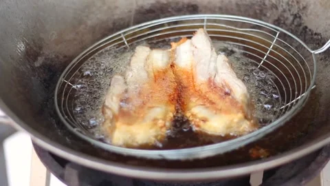 Crispy pork belly fried in hot oil in a pan on the gas stove for breakfast Stock-Footage 174029129