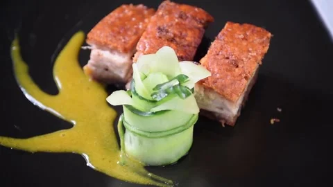 Crispy pork belly presentation with fresh herbs and sauce Stock Footage 320198805