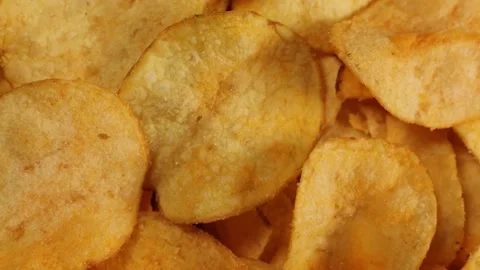 Crispy potato chips with cheddar cheese, rotating close up, macro Stock Footage 228922567