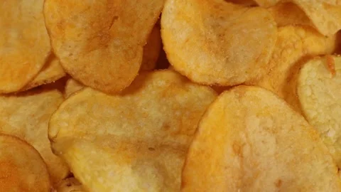 Crispy potato chips with cheddar cheese, rotating close up, macro Stock Footage 228922691