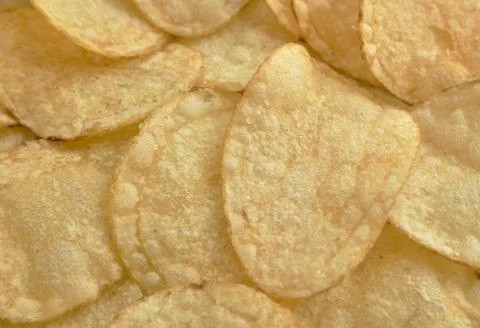 Crispy potato chips close-up, background, small sharpness depth Stock Photos