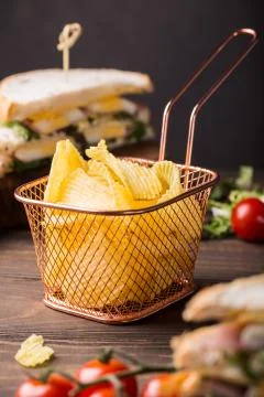 Crispy potato chips in copper basket 스톡 사진