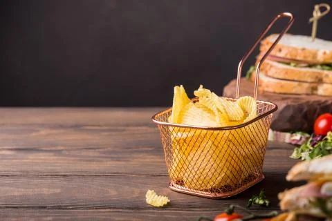 Crispy potato chips in copper basket Stock Photos