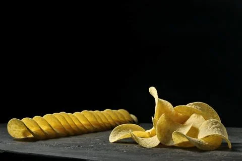Crispy potato chips on a dark background 库存照片