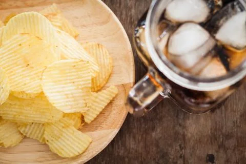 Crispy potato chips with iced cola Stock Photos